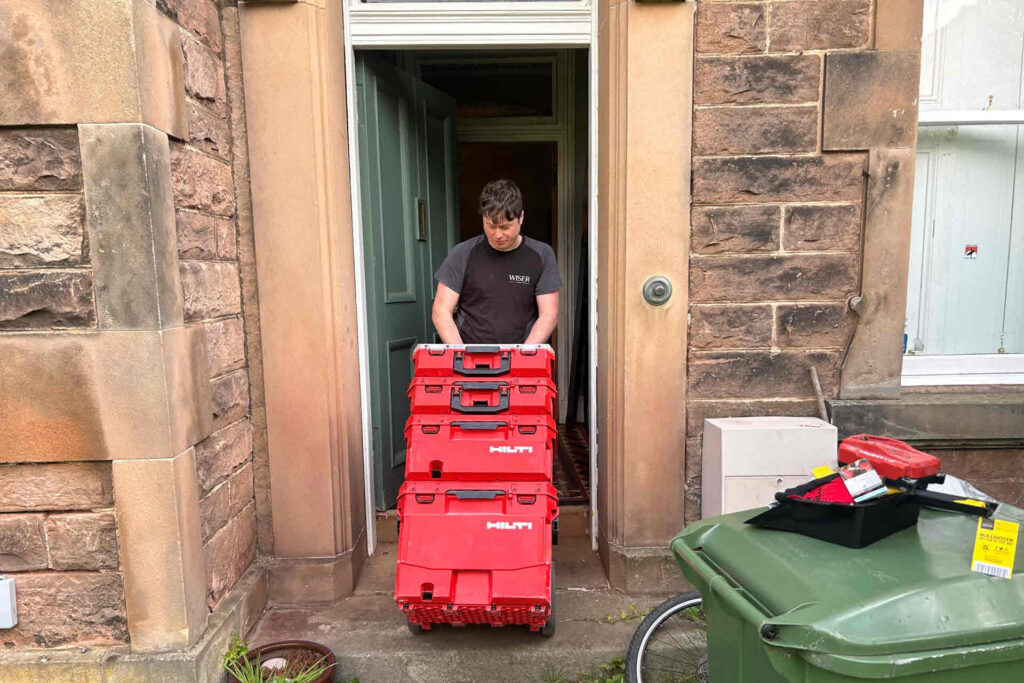 Wiser plumber working on repair at a customer home.